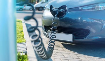 Plugged in charger into an electric car at charge station
